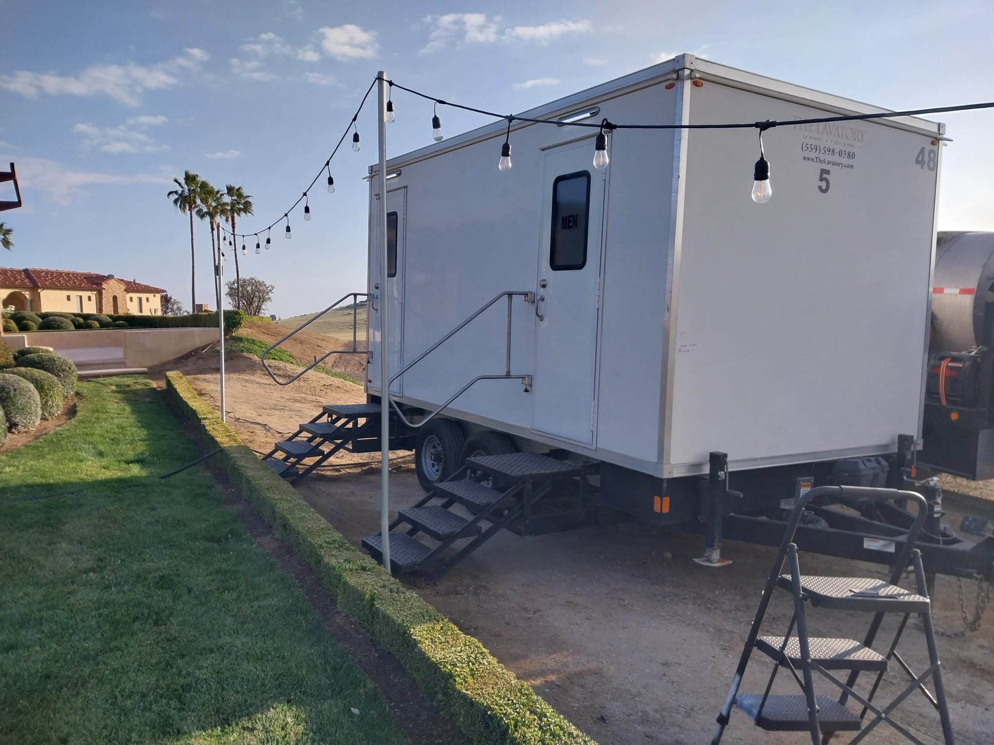 Texas wedding luxury restroom trailer rental. Elegant porcelain bathroom trailer at outdoor wedding venue
